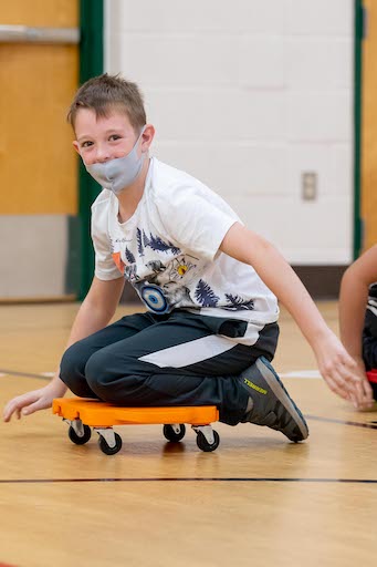 Student playing in gym class